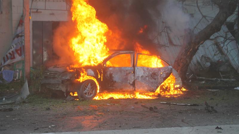 Al Jazeera / A car burns in the Somali capital after exploding on Monday in the city centre