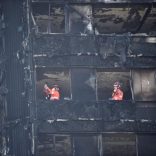 Members of the emergency services work inside the charred remains of the Grenfell apartment tower block in North Kensington, London, Britain, June 17, 2017. REUTERS/Hannah McKay