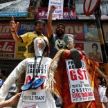 Cloth merchants and workers shout slogans before burning the effigies depicting India's Finance Minister Arun Jaitley and Textiles Minister Smriti Irani during a protest against implementation of Goods and Services Tax (GST) on textiles, in Kolkata, India, June 29, 2017. REUTERS/Rupak De Chowdhuri