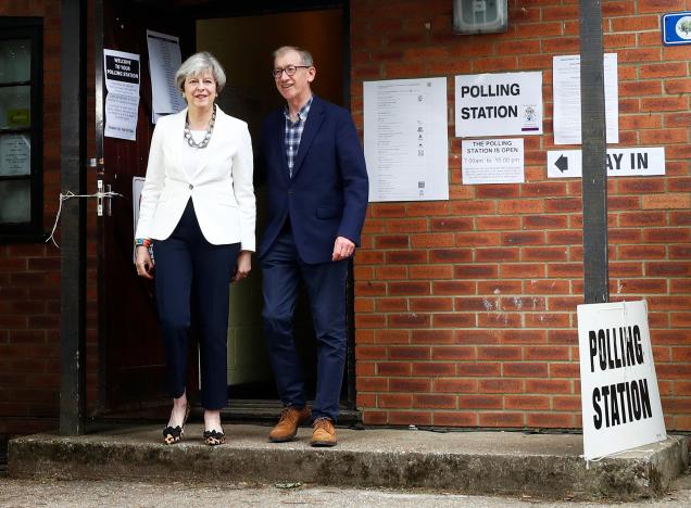 Britain's Primer Minister Theresa May and her husband Philip leave a polling station in Sonning, Britain, June 8, 2017. REUTERS/Eddie Keogh