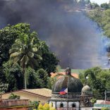 Smoke billowing from a burning building is seen as government troops continue their assault on insurgents from the Maute group, who have taken over large parts of Marawi City, Philippines June 2, 2017. REUTERS/Romeo Ranoco