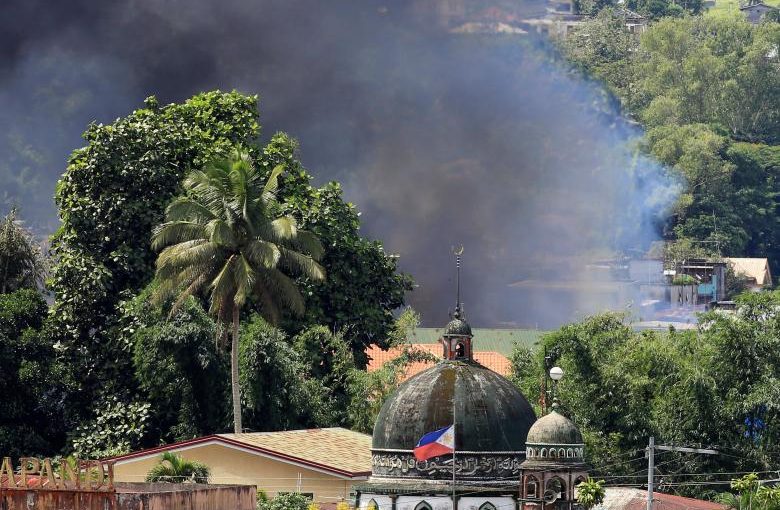 Smoke billowing from a burning building is seen as government troops continue their assault on insurgents from the Maute group, who have taken over large parts of Marawi City, Philippines June 2, 2017. REUTERS/Romeo Ranoco