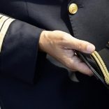 FILE PHOTO: An Alitalia pilot holds his cap at Fiumicino international airport in Rome September 24, 2008.  REUTERS/Max Rossi
