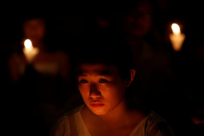 A girl takes part in a candlelight vigil to mark the 28th anniversary of the crackdown of the pro-democracy movement at Beijing's Tiananmen Square in 1989, at Victoria Park in Hong Kong, China June 4, 2017. REUTERS/Bobby Yip