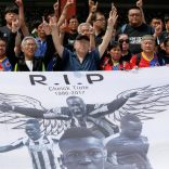 Supporters react behind a banner with image of soccer player Cheick Tiote, former Ivory Coast international who died in hospital last week after collapsing during a training session for his Chinese club Beijing Enterprises, during a memorial service in Beijing, China June 13, 2017. REUTERS/Damir Sagolj