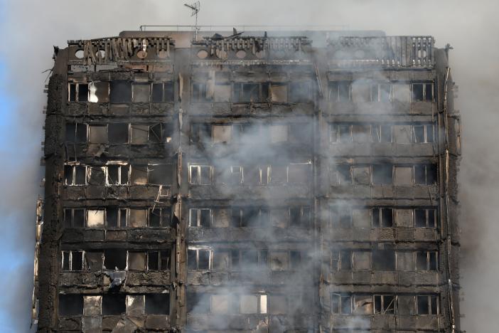 Smoke billows from a tower block severly damaged by a serious fire, in north Kensington, West London, Britain June 14, 2017. REUTERS/Neil Hall