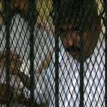 FILE PHOTO: Hesham Talaat Moustafa, former chairman of the Talaat Moustafa Group, stands inside a cage at a court in Cairo, Egypt June 25, 2009.  REUTERS/Asmaa Waguih/File Photo