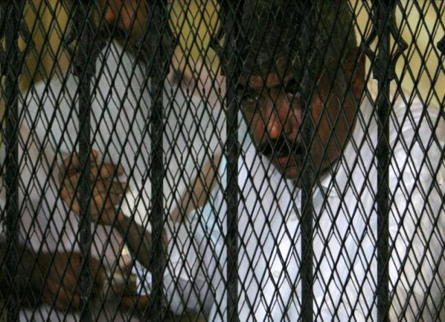 FILE PHOTO: Hesham Talaat Moustafa, former chairman of the Talaat Moustafa Group, stands inside a cage at a court in Cairo, Egypt June 25, 2009.  REUTERS/Asmaa Waguih/File Photo
