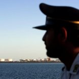 FILE PHOTO: A security personnel looks on at oil docks at the port of Kalantari in the city of Chabahar, 300km (186 miles) east of the Strait of Hormuz, Iran January 17, 2012. REUTERS/Raheb Homavandi/File Photo