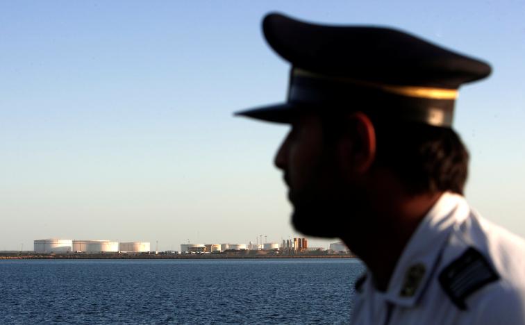 FILE PHOTO: A security personnel looks on at oil docks at the port of Kalantari in the city of Chabahar, 300km (186 miles) east of the Strait of Hormuz, Iran January 17, 2012. REUTERS/Raheb Homavandi/File Photo