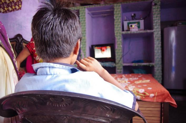 A family in a village watch Simpa Magic TV, the country's first solar-powered satellite television service in their home in Mathura district in Uttar Pradesh. (HANDOUT/SIMPA NETWORKS)