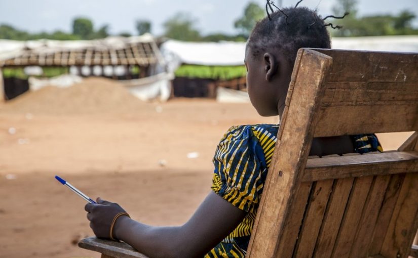 A former child combatant, 14, who used to be a member of the anti-balaka rebel group sits outside her school building in Bambari, Central African Republic November 10, 2015. The girl's identity is being protected by UNICEF, the U.N.'s children’s agency, after it helped her leave the armed faction to pursue her education. The girl had admitted to playing a role in killing members of an opposing armed group to avenge the death of two male relatives. Picture taken November 10, 2015. To match Feature CENTRALAFRICA-CHILDSOLDIERS/     REUTERS/Tom Esslemont/Thomson Reuters Foundation