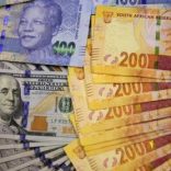 South African bank notes featuring images of former South African President Nelson Mandela (R) are displayed next to the American dollar notes in this photo illustration in Johannesburg August 13 2014.   REUTERS/Siphiwe Sibeko