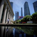 A man walks at Lujiazui financial district of Pudong in Shanghai, China July 17, 2017. REUTERS/Aly Song