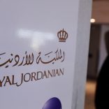 A traveler walks past a sign for Royal Jordanian airline at JFK International Airport in New York, U.S., March 21, 2017.  REUTERS/Lucas Jackson