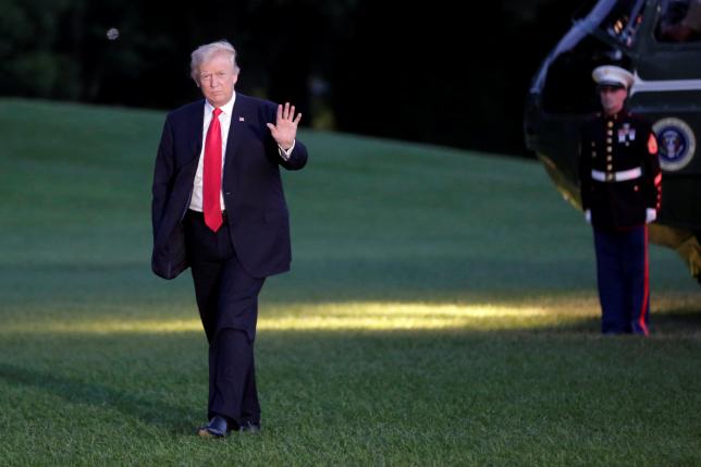U.S. President Donald Trump waves as walks on the South Lawn of the White House upon his return to Washington, U.S., from the G20 Summit in Hamburg, July 8, 2017. REUTERS/Yuri Gripas