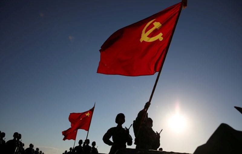 Soldiers carry a PLA flag and Chinese national flags before the military parade to commemorate the 90th anniversary of the foundation of China's People's Liberation Army (PLA) at Zhurihe military base in Inner Mongolia Autonomous Region, China, July 30, 2017. REUTERS/Stringer