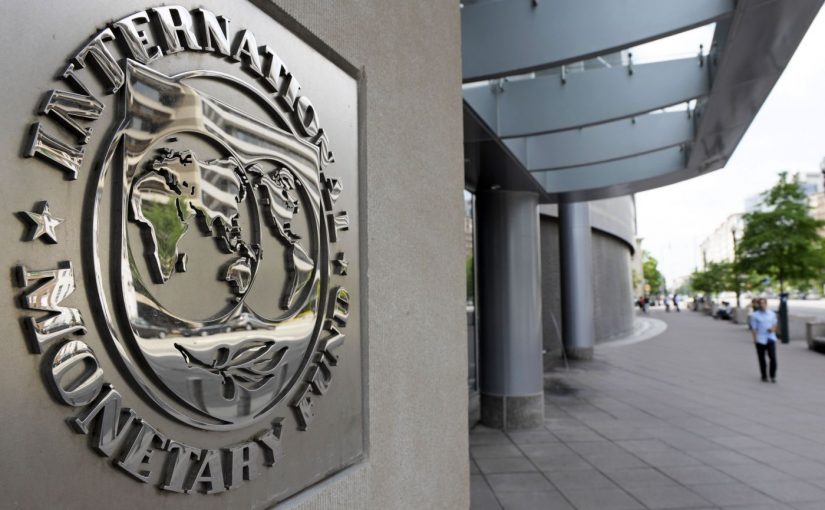 Pedestrians walk past the International Monetary Fund headquarters' complex in Washington Sunday, May 2, 2010. A senior International Monetary Fund official says the IMF's executive board is meeting in Washington to consider how much aid to grant Athens under a massive rescue loan package. (AP Photo/Cliff Owen)