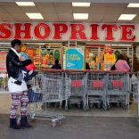 A shopper is seen outside a Shoprite store in Johannesburg July 7, 2015.  REUTERS/Siphiwe Sibeko/File Photo - RTX2MO0A