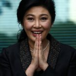 FILE PHOTO: Ousted former Thai prime minister Yingluck Shinawatra greets supporters as she arrives at the Supreme Court in Bangkok
