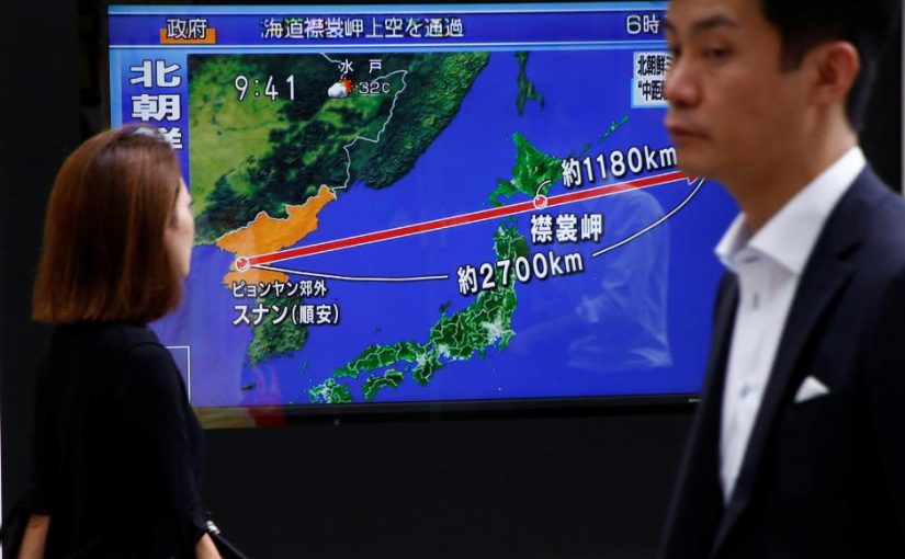 Pedestrians walk past a TV set showing news about North Korea's missile launch in Tokyo, Japan, August 29, 2017.   REUTERS/Kim Kyung-Hoon