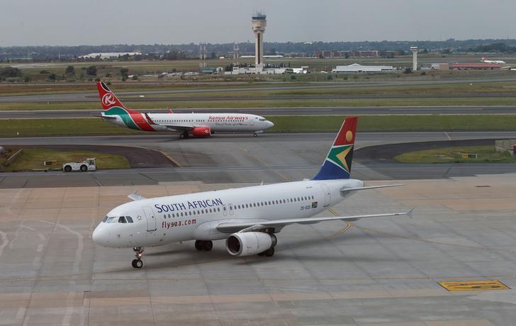 FILE PHOTO: A South African Airways aircraft (bottom) arrives as a Kenya Airways aircraft prepares to take off at the OR Tambo International Airport in Johannesburg, South Africa, March 8, 2017. REUTERS/Siphiwe Sibeko/File Photo