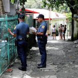 Policemen knock door to door and interview residents during a drug testing operation in Payatas, Quezon City, Metro Manila