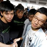 Student leaders Lester Shum, Alex Chow, Joshua Wong and Nathan Law hold hands as they walk into the High Court to face verdict on charges relating to the 2014 pro-democracy Umbrella Movement, also known as Occupy Central protests, in Hong Kong, China August 17, 2017. REUTERS/Tyrone Siu