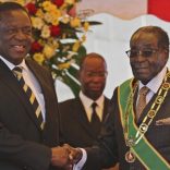 FILE PHOTO: President Robert Mugabe (R) greets Vice President Emmerson Mnangagwa as he arrives for  Zimbabwe's Heroes Day commemorations in Harare, August 10, 2015. REUTERS/Philimon Bulawayo