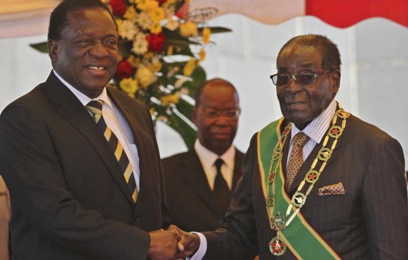 FILE PHOTO: President Robert Mugabe (R) greets Vice President Emmerson Mnangagwa as he arrives for  Zimbabwe's Heroes Day commemorations in Harare, August 10, 2015. REUTERS/Philimon Bulawayo