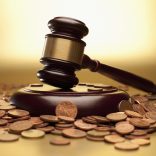 Gavel and sound block surrounded by euro coins