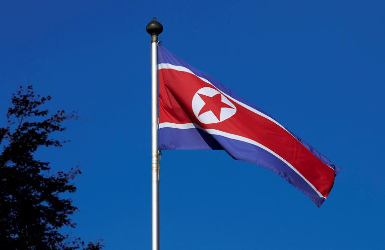 FILE PHOTO - A North Korean flag flies on a mast at the Permanent Mission of North Korea in Geneva October 2, 2014. REUTERS/Denis Balibouse/File Photo