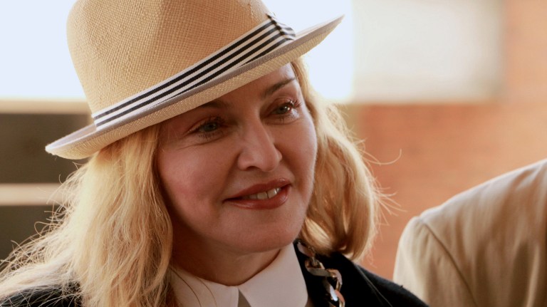 US pop diva Madonna looks on during the inspection of a 50-bed surgical unit for children that her charity, Raising Malawi, is funding at Queens Elizabeth hospital in the commercial capital Blantyre on July 10, 2016. 
Madonna shrugged off controversies about her relationship with Malawi, the homeland of her two adopted children, and spoke freely of her family life during a visit to the country July 10. 
 / AFP PHOTO / ELDSON CHAGARA