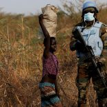 FILE PHOTO: A United Nations Mission in South Sudan (UNMISS) peacekeeping soldier stands guard as children walk by during a patrol close to the town of Bentiu in Rubkona county, northern South Sudan, February 11, 2017. REUTERS/Siegfried Modola/File Photo