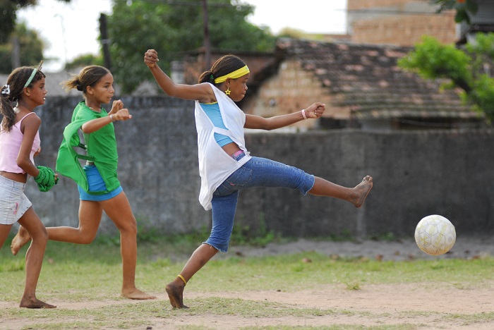 Girls play football in a schoolyard in the city of Olinda in the north-eastern state of Pernambuco. The game was organized by the local NGO PETI (Programme for the Eradication of Child Labour), a UNICEF-assisted organization that offers sports and cultural activities to children from marginalized communities.

In 2006 in Brazil, favourable economic trends mask striking racial, ethnic, gender, geographic and urban/rural disparities. For example, black children are 78 per cent more likely to live in poverty than white children, and children in rural areas are twice as likely to be poor than those living in urban areas. While the nation boasts the world's ninth largest economy, it also has one of the highest income gaps between rich and poor. This inequity manifests itself in every aspect of life, from basic services, healthcare and education to access to clean water and improved sanitation. Yet the nation's response to HIV/AIDS is recognized as one of the best in the world. The Ministry of Health provides free, universal antiretroviral (ARV) therapy to all HIV-positive children and adults who need it, as well as expanded HIV/AIDS prevention, treatment and care programmes for pregnant women and young people. Nevertheless, significant regional and social challenges remain. The number of AIDS cases among blacks and women continues to grow at a much higher rate than for whites and men. In 1985, the male-to-female ratio of AIDS cases was 23 to 1; today it is 1.5 to 1. Among adolescents, this ratio has already inverted, and there are now 1.5 AIDS cases among girls for every boy. UNICEF supports HIV/AIDS prevention, treatment and care for all children, adolescents and pregnant women; equal access to health, nutrition and education for all children; and comprehensive youth development to discourage child labour and promote racial and ethnic equality.